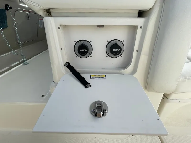 Slide: The Image of 2006 Sea Ray 320 Sundancer boat compartment with speakers and latch. - 32