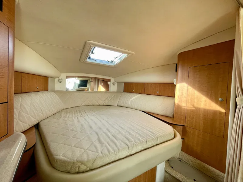 Slide: The Image of Interior cabin of 2006 Sea Ray 320 Sundancer with bed and wooden cabinetry. - 8