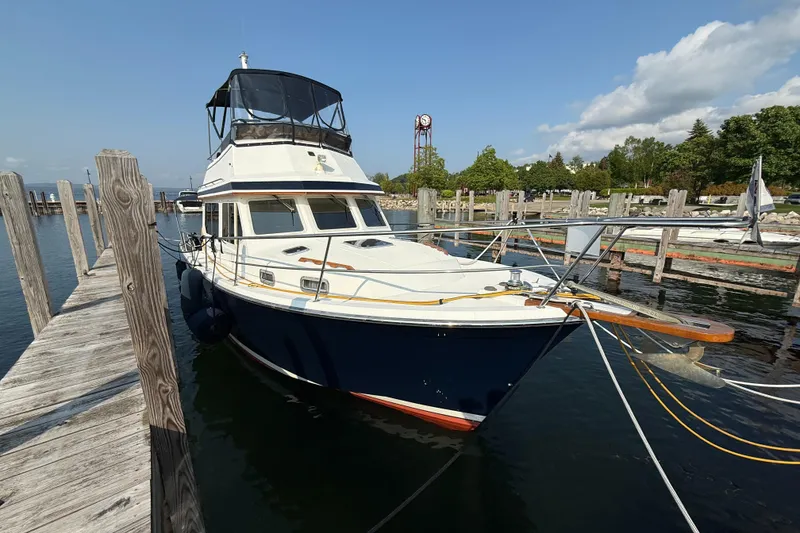 Slide: The Image of Sabreline 34 Flybridge 1999 docked at a marina under a clear blue sky. - 11