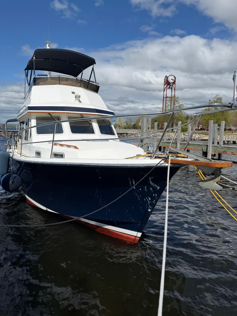 Slide: The Image of 1999 Sabreline 34 Flybridge boat docked, featuring a sleek design and spacious flybridge. - 12