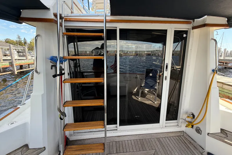 Slide: The Image of 1999 Sabreline 34 Flybridge yacht with wooden steps and sliding glass doors. - 24