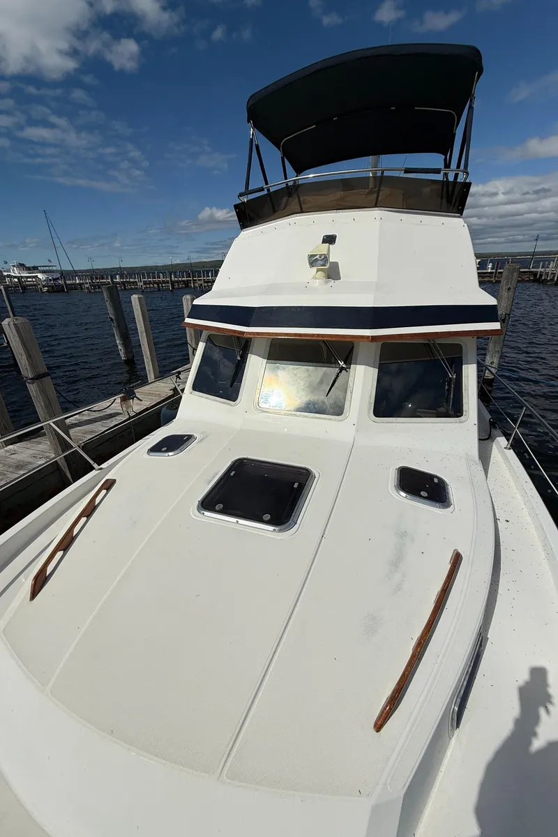 Slide: The Image of 1999 Sabre Sabreline 34 Flybridge boat docked, showcasing sleek design and spacious flybridge. - 27