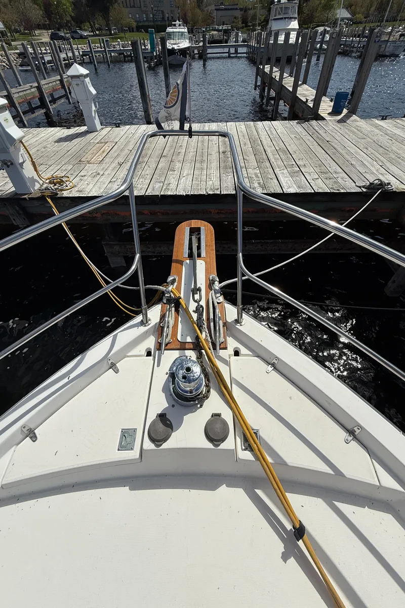 Slide: The Image of Bow view of 1999 Sabreline 34 Flybridge docked at a marina. - 29