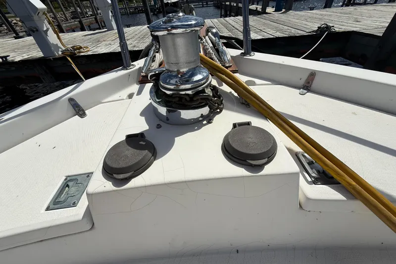 Slide: The Image of 1999 Sabreline 34 Flybridge deck with winch and mooring lines at dock. - 30