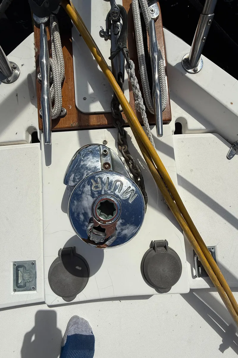 Slide: The Image of Deck view of a 1999 Sabre Sabreline 34 Flybridge, featuring a winch and nautical equipment. - 31