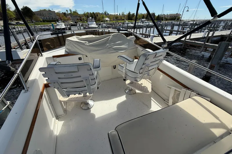 Slide: The Image of 1999 Sabreline 34 Flybridge with covered seating, docked at a marina. - 32