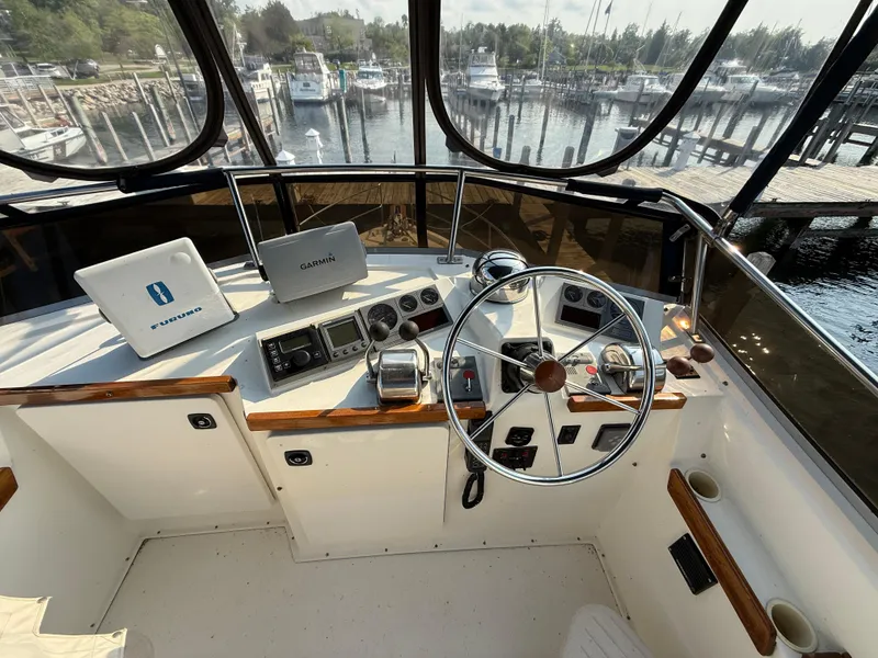 Slide: The Image of Flybridge helm of 1999 Sabreline 34 with navigation equipment, overlooking marina. - 33