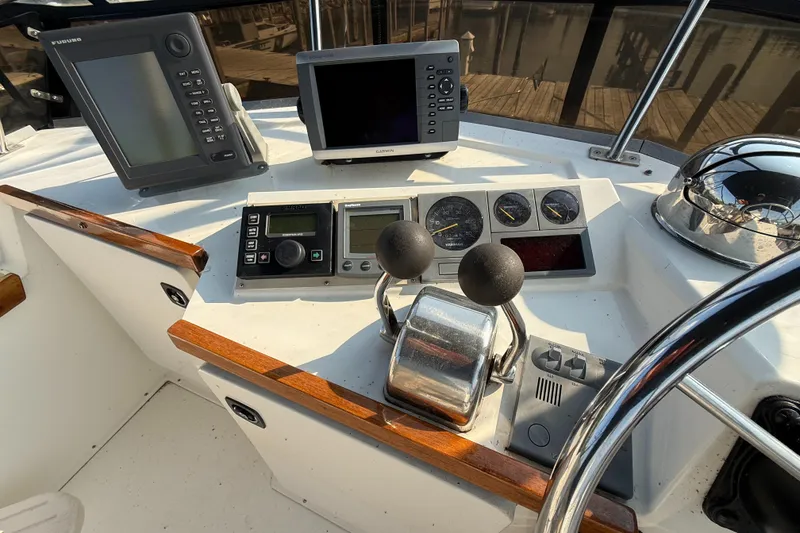 Slide: The Image of 1999 Sabreline 34 Flybridge helm with navigation equipment and controls. - 35