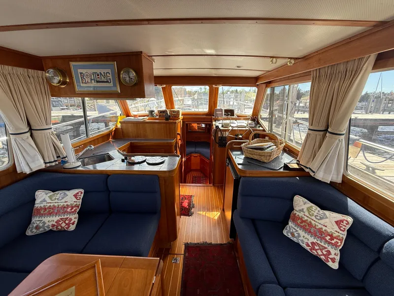 Slide: The Image of Interior of 1999 Sabreline 34 Flybridge yacht with cozy seating and nautical decor. - 40