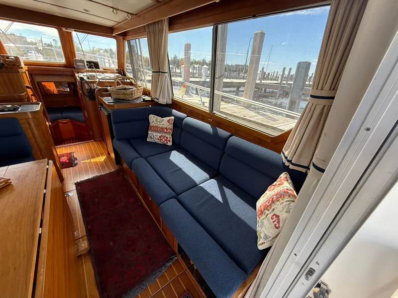 Slide: The Image of Interior of 1999 Sabreline 34 Flybridge with blue seating and nautical decor. - 45