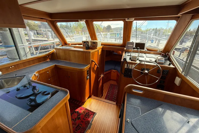 Slide: The Image of Interior of 1999 Sabreline 34 Flybridge with wooden finish and helm station. - 49
