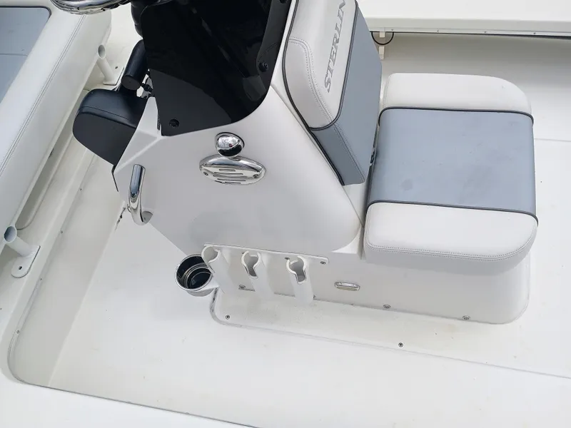 Slide: The Image of Sterling 180TS 2023 boat interior with white and gray seating and control panel. - 15