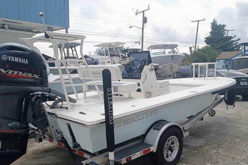 Slide: The Image of 2023 Sterling 180TS boat on trailer with Yamaha engine, parked outdoors. - 18