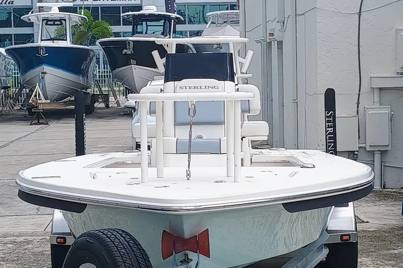Slide: The Image of 2023 Sterling 180TS boat on trailer, docked with other boats in background. - 5