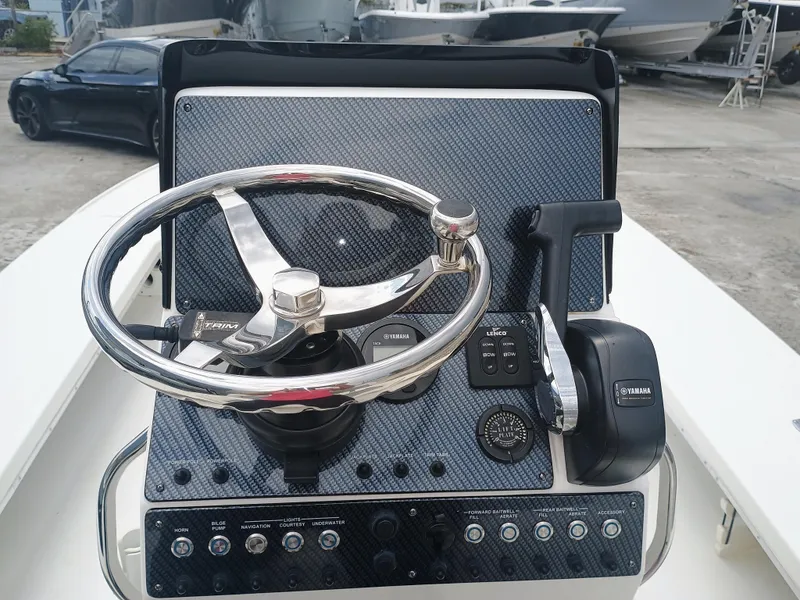 Slide: The Image of 2023 Sterling 180TS boat dashboard with steering wheel and control panel. - 9