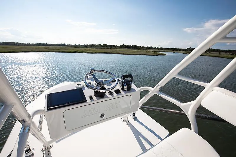 Slide: The Image of 2017 SeaVee 390OZ boat helm with scenic waterway view. - 12