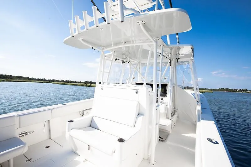 Slide: The Image of 2017 SeaVee 390OZ boat on calm water, featuring sleek white design and spacious deck. - 13