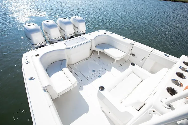 Slide: The Image of 2017 SeaVee 390OZ boat with spacious seating and four outboard engines on water. - 15