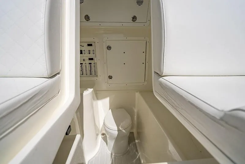 Slide: The Image of Interior of 2017 SeaVee 390OZ boat featuring a compact marine toilet. - 3