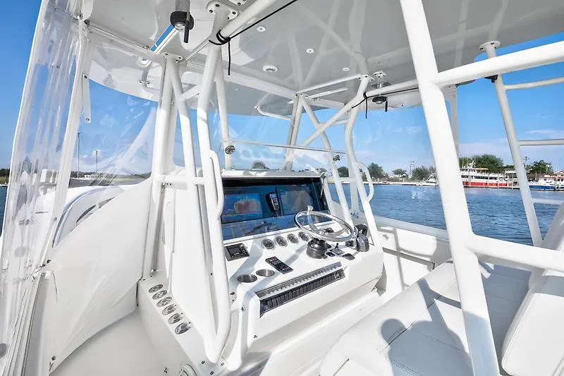 Slide: The Image of 2017 SeaVee 390OZ boat cockpit with modern controls and clear canopy on a sunny day. - 6