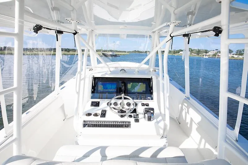 Slide: The Image of 2017 SeaVee 390OZ boat cockpit with steering wheel and navigation screens on a sunny day. - 9