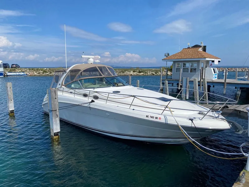 The Image of 2003 Sea Ray 360 Sundancer docked at a marina under a clear blue sky. - 0