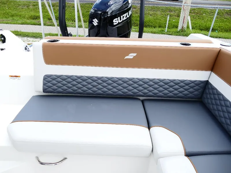 Slide: The Image of 2026 Starcraft SVX 231 OB boat interior with stylish quilted seating and Suzuki outboard motor. - 19