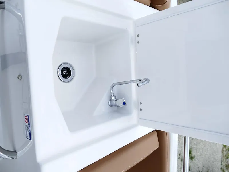 Slide: The Image of 2026 Starcraft SVX 231 OB boat sink with faucet and storage compartment. - 22