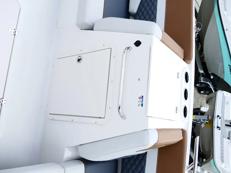 Slide: The Image of 2026 Starcraft SVX 231 OB boat interior with cushioned seating and storage compartment. - 23