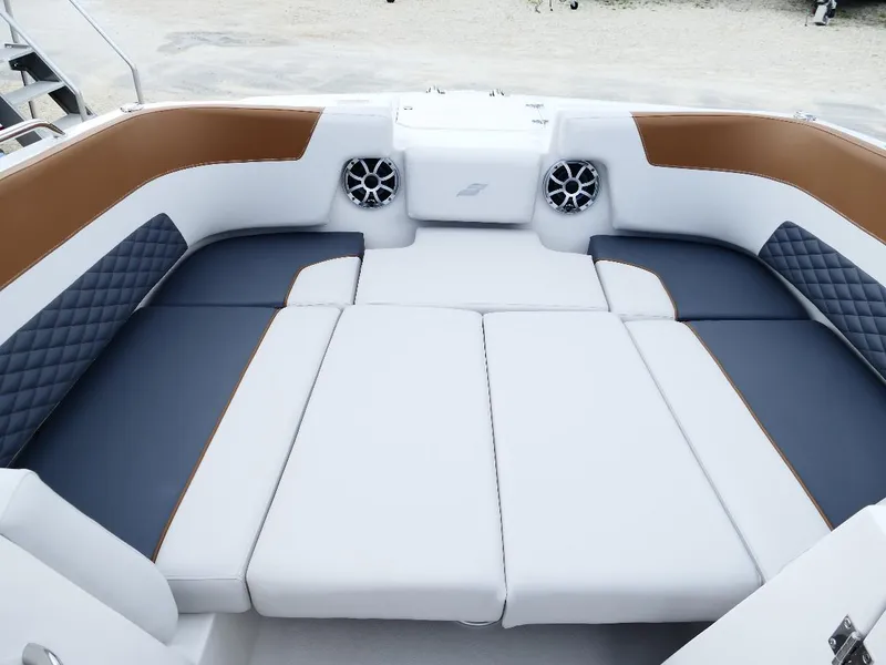 Slide: The Image of 2026 Starcraft SVX 231 OB boat interior with cushioned seating and speakers. - 33