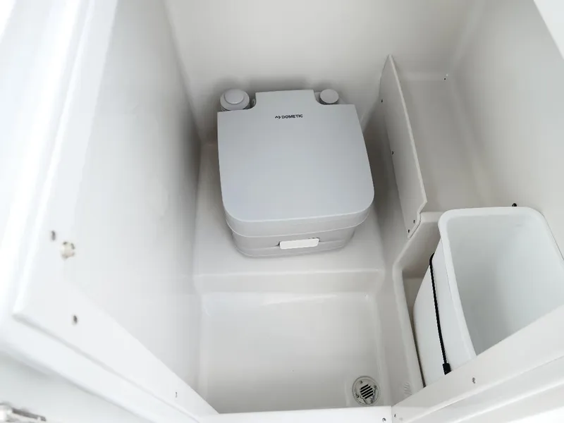 Slide: The Image of 2026 Starcraft SVX 231 OB boat interior with compact portable toilet. - 36