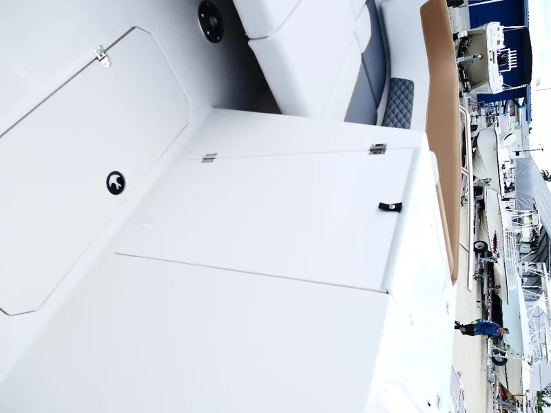 Slide: The Image of 2026 Starcraft SVX 231 OB boat interior with white seating and storage compartments. - 38