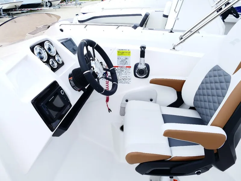 Slide: The Image of 2026 Starcraft SVX 231 OB boat cockpit with modern steering and controls. - 40