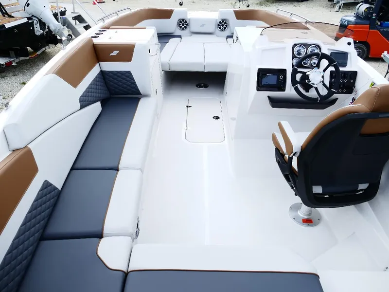 Slide: The Image of 2026 Starcraft SVX 231 OB boat interior with modern seating and steering console. - 46