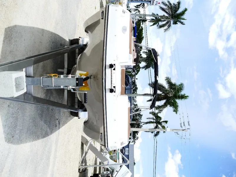 Slide: The Image of 2026 Starcraft SVX 231 OB boat on trailer, parked outdoors under clear sky. - 5