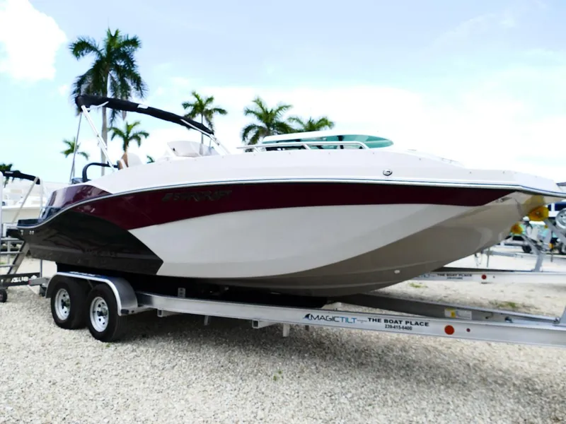Slide: The Image of 2026 Starcraft SVX 231 OB boat on trailer, palm trees in background. - 6