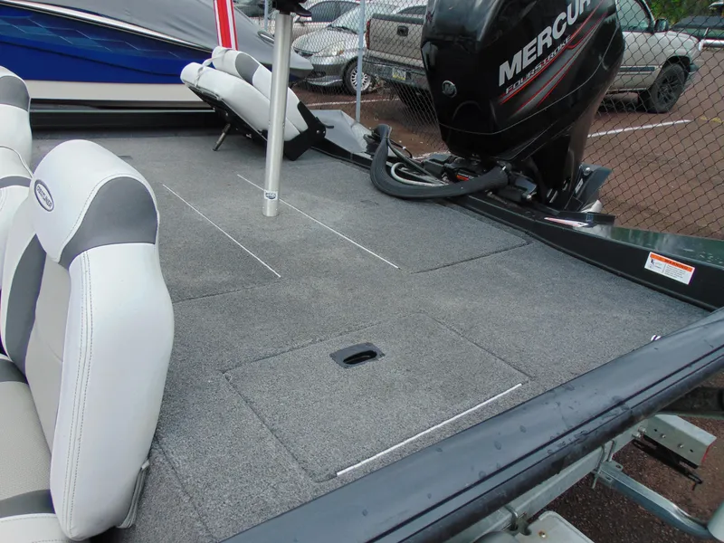 Slide: The Image of 2014 Crestliner VT 19 boat interior with Mercury engine, featuring spacious seating and storage. - 10