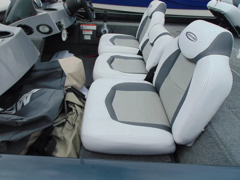 Slide: The Image of 2014 Crestliner VT 19 boat interior with three white and gray seats. - 9