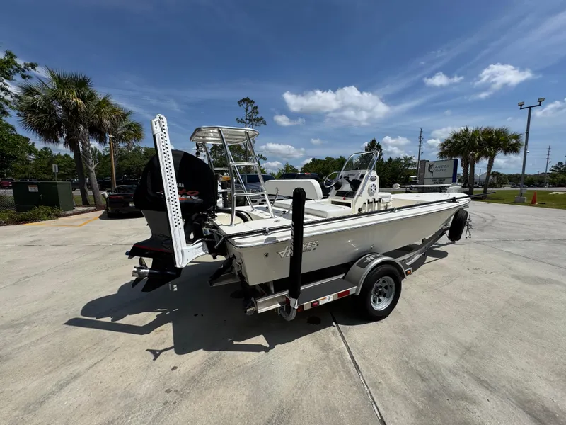 Slide: The Image of 2021 Hewes Redfisher 18 boat on trailer, parked outdoors under a clear sky. - 12