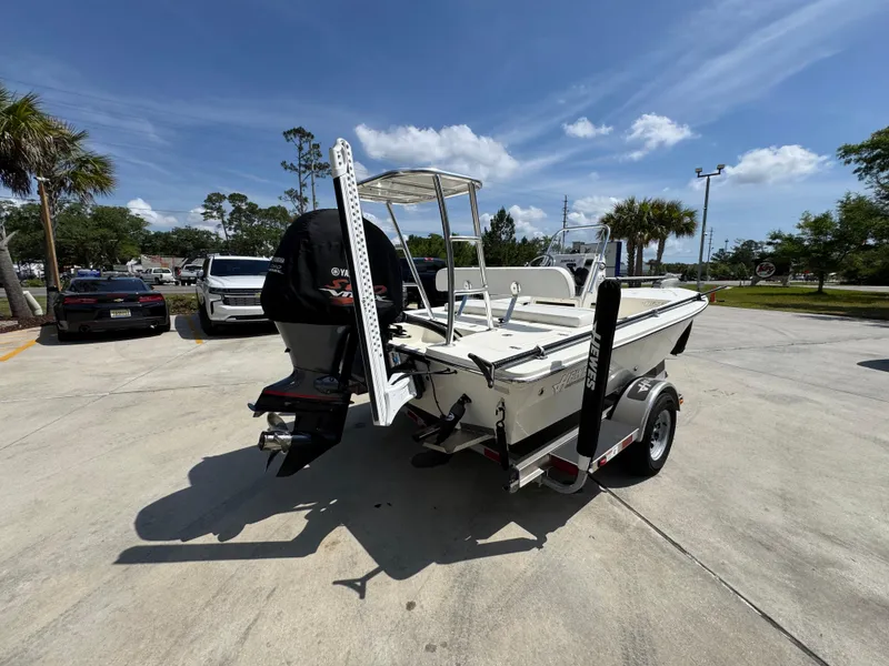 Slide: The Image of 2021 Hewes Redfisher 18 boat on trailer in sunny outdoor setting. - 13