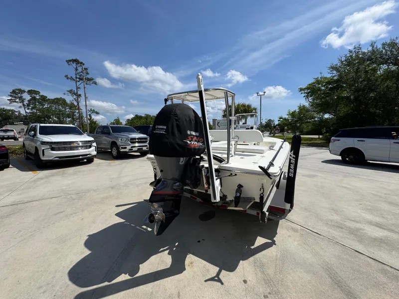 Slide: The Image of 2021 Hewes Redfisher 18 boat in parking lot, rear view with motor. - 14
