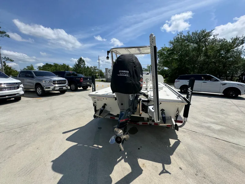 Slide: The Image of 2021 Hewes Redfisher 18 boat on trailer, parked in a lot with cars. - 15