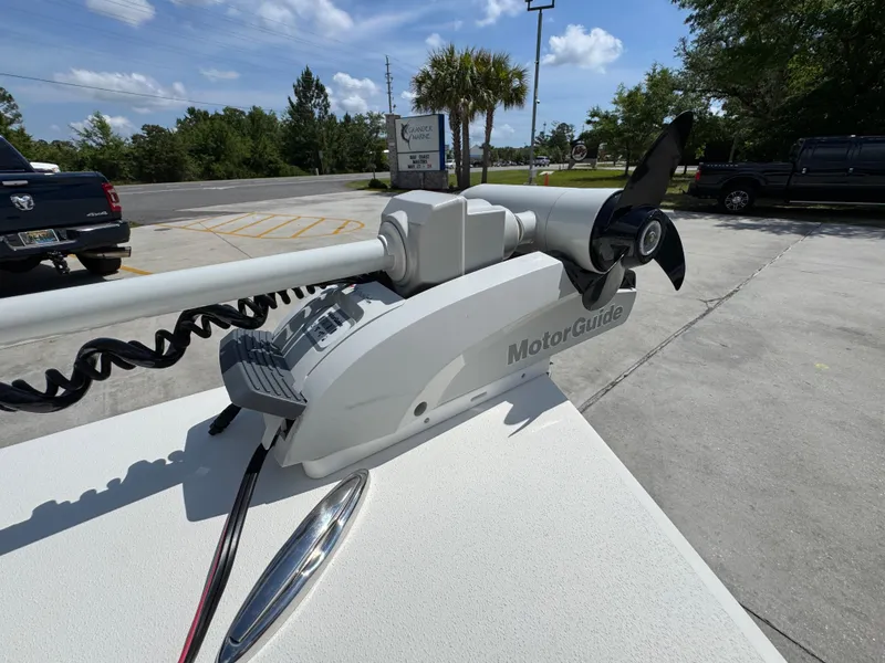 Slide: The Image of 2021 Hewes Redfisher 18 with MotorGuide trolling motor in a parking lot. - 24