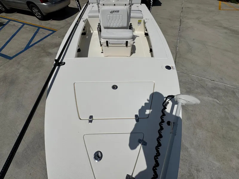 Slide: The Image of 2021 Hewes Redfisher 18 boat, white deck, parked on concrete surface. - 25