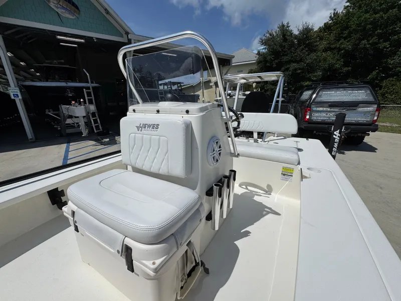 Slide: The Image of 2021 Hewes Redfisher 18 boat with white seating and console, parked outdoors. - 28