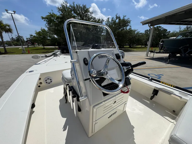 Slide: The Image of 2021 Hewes Redfisher 18 boat, center console, steering wheel, outdoor setting, sunny day. - 30