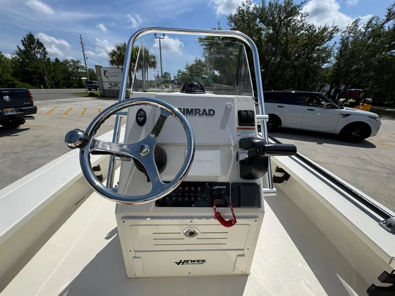 Slide: The Image of 2021 Hewes Redfisher 18 boat console with steering wheel and Simrad electronics. - 31