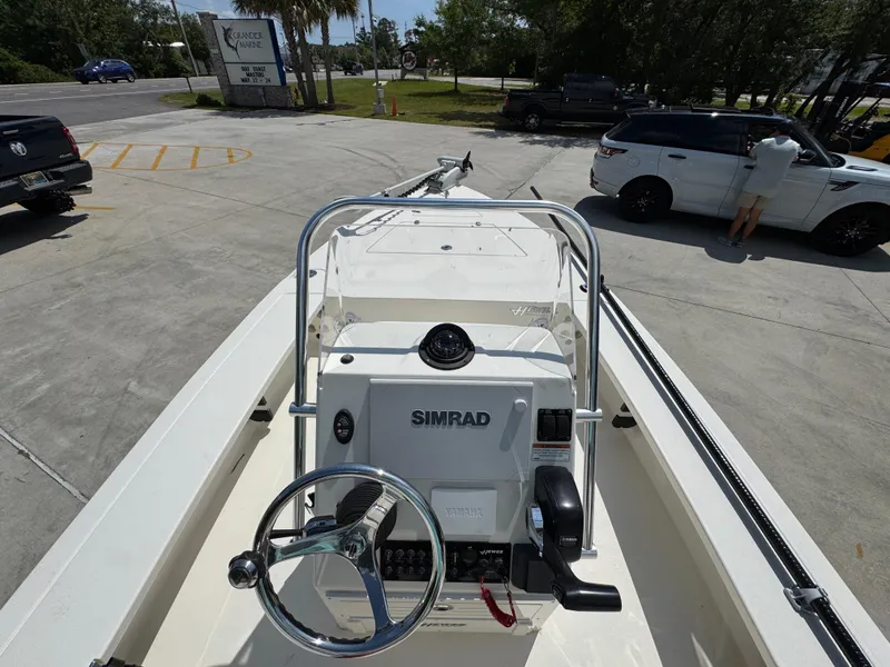 Slide: The Image of 2021 Hewes Redfisher 18 boat with Simrad navigation, parked outdoors. - 33