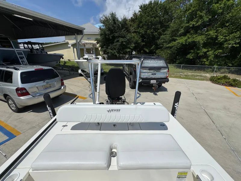 Slide: The Image of 2021 Hewes Redfisher 18 boat parked in a driveway with cars and trees nearby. - 36