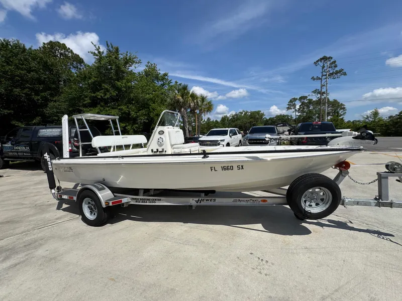 Slide: The Image of 2021 Hewes Redfisher 18 boat on trailer in sunny parking lot. - 9